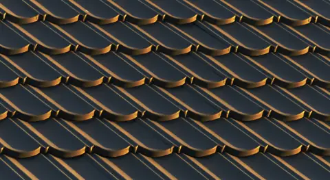 Close-up of dark overlapping roof tiles